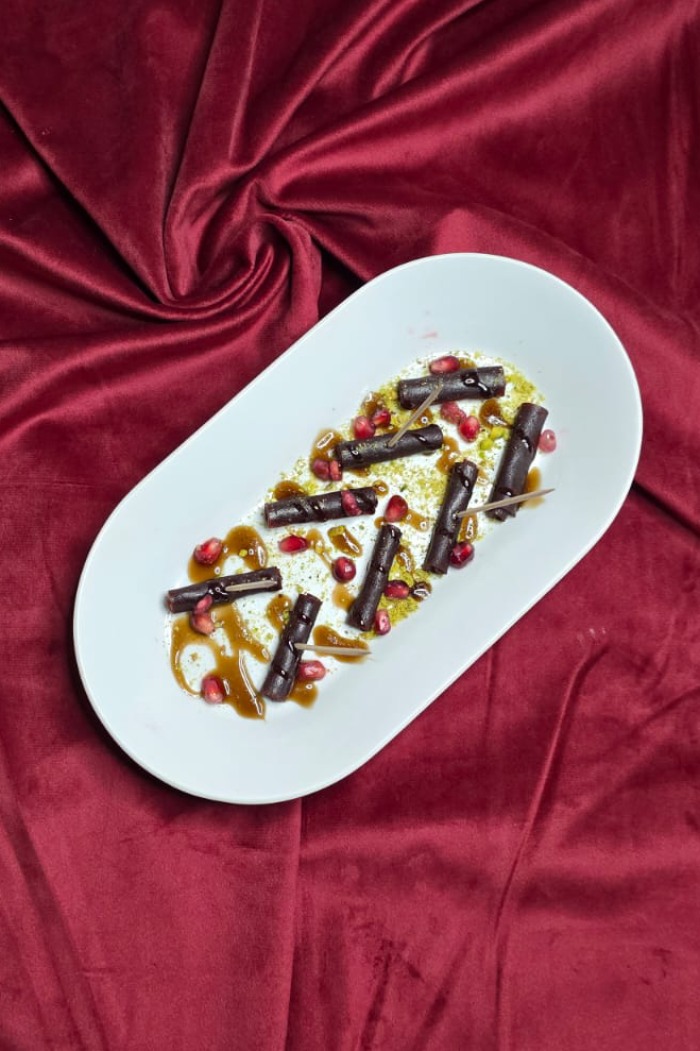 Ziba Restaurant Tart and sweet fruit leather arranged on a plate, possibly with sauce in 
Dunfermline.